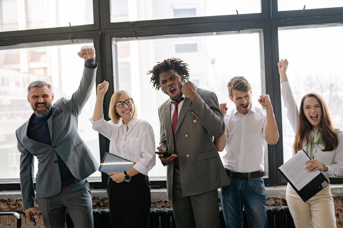 Team celebrating a successful brand launch in the office
