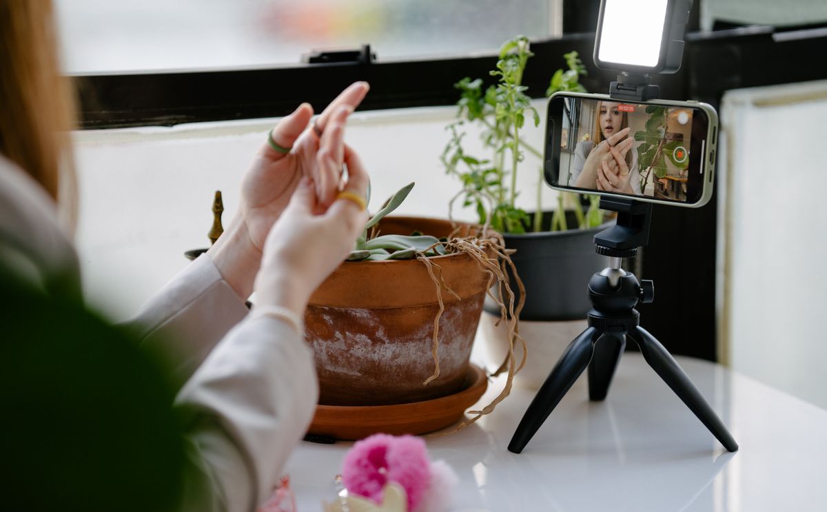 Content creator recording video with a tripod