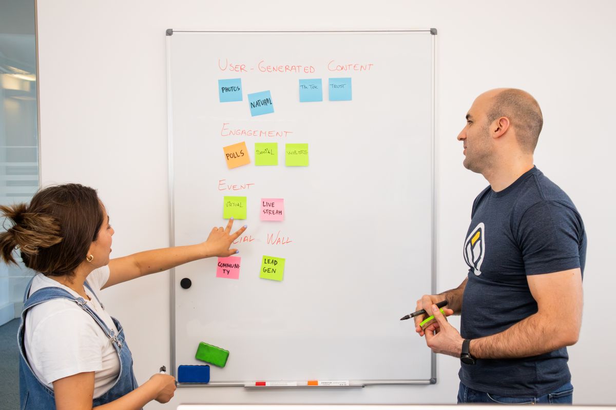 Colleagues planning strategy at a whiteboard