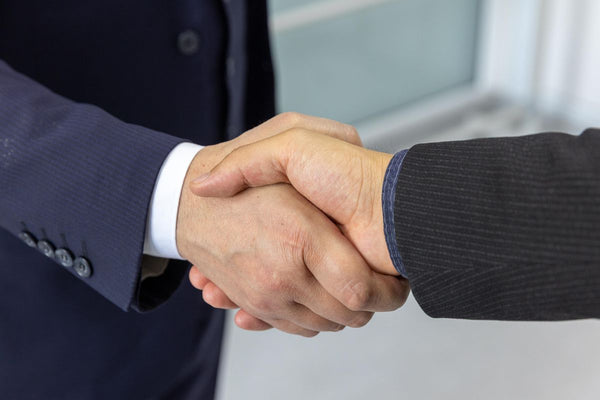 Business partners shaking hands on a leadership agreement